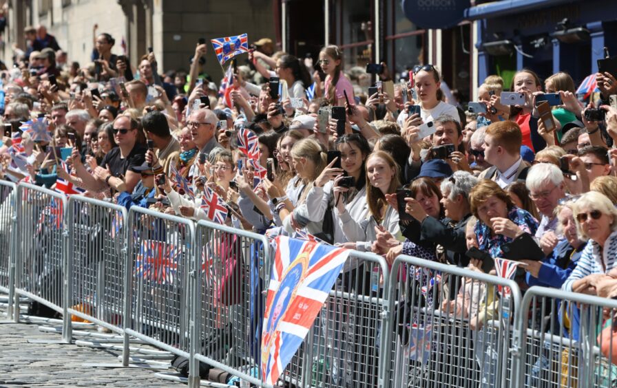 Crowds on the Royal Mile for the Royal Procession on the Royal Mile, Edinburgh. King Charles III, accompanied by Queen Camilla.