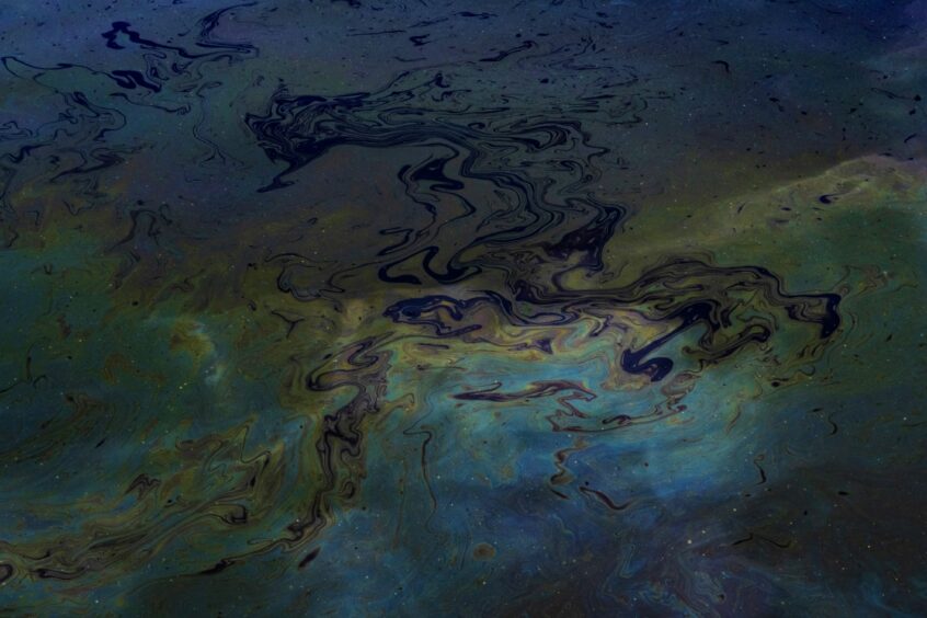 An oil spill floating on water.