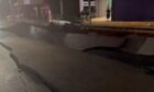 A Johannesburg street with big cracks in from an explosion, that may have been caused by a gas leak