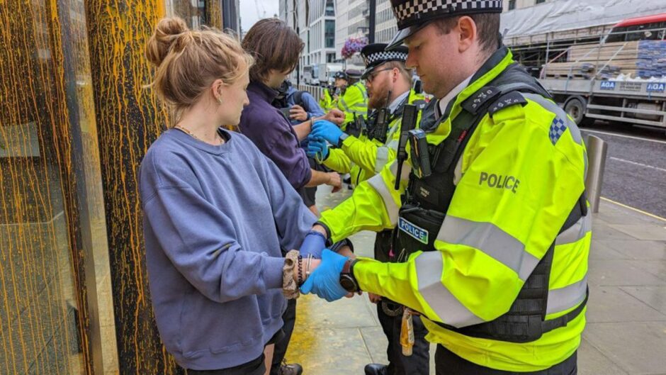 Police in attendance as Just Stop Oil hit the offices of the DESNZ with trademark orange paint