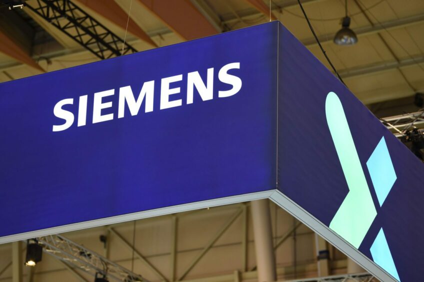 A logo above the Siemens AG booth on day two of the Web Summit in Lisbon, Portugal, on Thursday, Nov. 3, 2022. The Web Summit runs from 1-4 November. Photographer: Zed Jameson/Bloomberg