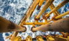 Pipes leading down into rough seas with surface corrosion