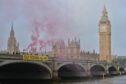 Fossil Free London Activists unveil a Stop Rosebank banner on Westminster Bridge.