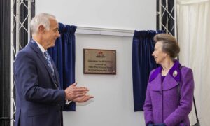 Princess Anne unveils a plaque on the official opening of the expanded Port of Aberdeen as a man looks on