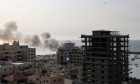 A plume of smoke rises above the port in the Gaza Strip after an Israeli air strike on Oct. 8, 2023.