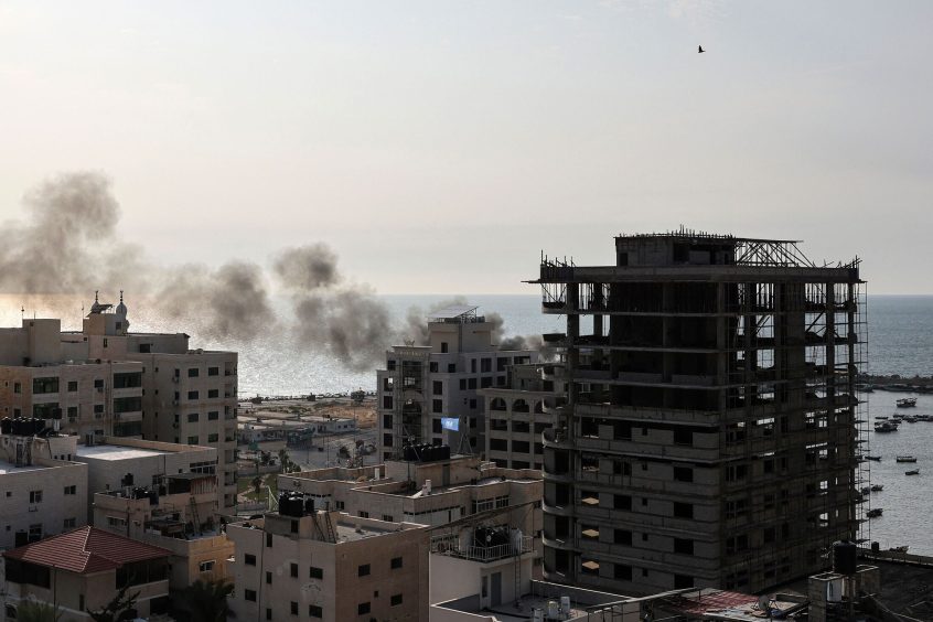 A plume of smoke rises above the port in the Gaza Strip after an Israeli air strike on Oct. 8, 2023.