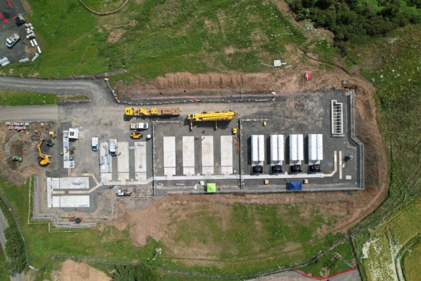 Aerial shot of Tesla megapacks arriving at Little Raith BESS in Fife.