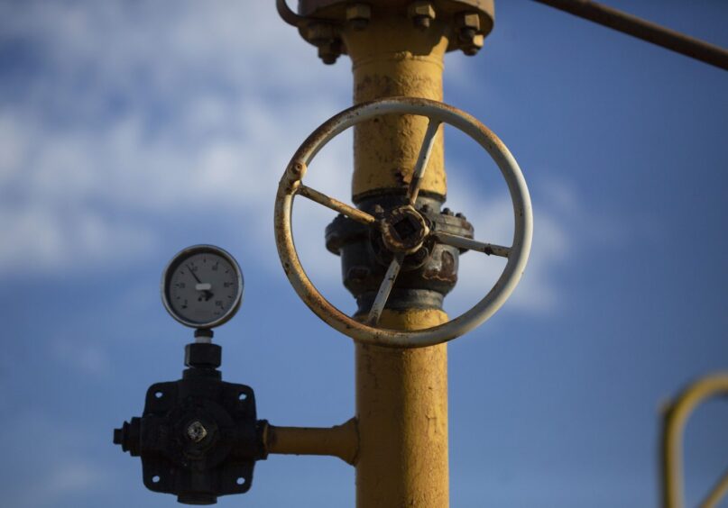 A pressure gauge and valve wheel on yellow pipework at a gas storage facility. Photographer: Bloomberg Creative Photos/Bloomberg Creative Collection