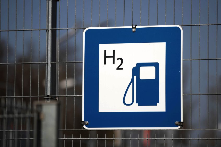 A chemical symbol on a hydrogen fuel pump sign at a railway train refueling station in Salzgitter, Germany, on Tuesday, April 20, 2021.