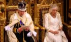 King Charles III delivers a speech beside Queen Camilla during the State Opening of Parliament in the House of Lords at the Palace of Westminster in London.