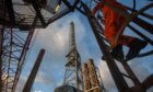 A worker climbs a crane ladder on the weather deck of the Armada gas condensate platform. Pic: Bloomberg.