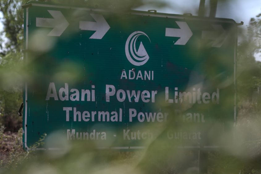 Signage of the Mundra Thermal Power Plant of Adani Power Ltd., sit on displayed in Mundra, Gujarat, India, on Thursday, Feb. 9, 2023.
