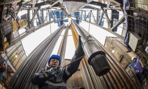 A worker guides drilling pipes at a gas drilling rig on the Gazprom PJSC Chayandinskoye oil, gas and condensate field, a resource base for the Power of Siberia gas pipeline, in the Lensk district of the Sakha Republic, Russia, on Wednesday, Oct. 13, 2021. Andrey Rudakov/Bloomberg