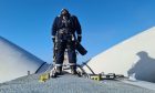 Glacier Energy worker carries out a wind turbine inspection.