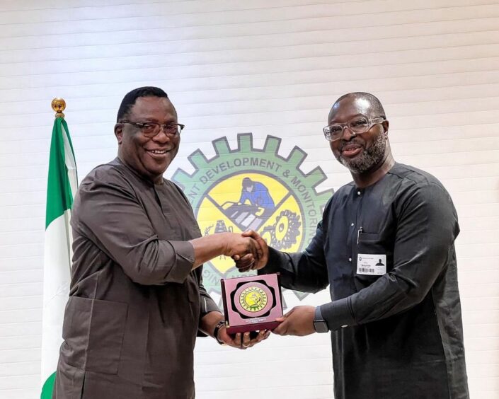 Timi Austen-Peters of Dorman Long shakes hands with NCDMB head Felix Omatsola Ogbe