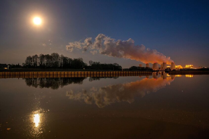 Vapor rises from cooling towers at the Jaenschwalde lignite-fired power plant, operated by Lausitz Energie Bergbau AG (LEAG), at night in Peitz, Germany, on Saturday, Feb. 8, 2020. Under Germany's fossil phasing agreement announced last month, LEAG?s Jaenschwalde power plant is to be transformed into a gas-fired unit. Photographer: Krisztian Bocsi/Bloomberg