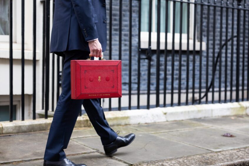 The Chancellor Jeremy Hunt walks outside Downing Street with the Budget box. Supplied by Zara Farrar / HM Treasury