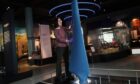 Curator Ellie Swinbank installs the Nova tidal turbine blade at the National Museum of Scotland in Edinburgh.