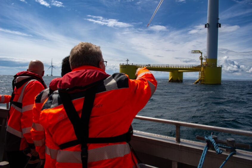 Staff pointing at offshore wind