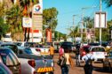 Pedestrians walk past parked vehicles outside a Total SA gas station in Maputo, Mozambique, on Thursday, March 23, 2017. Mozambique missed a $119 million payment due Tuesday on a loan Credit Suisse Group AG arranged, the second debt repayment the government failed to make in as many months.