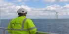 An OPS Wind employee overlooking an offshore wind farm.