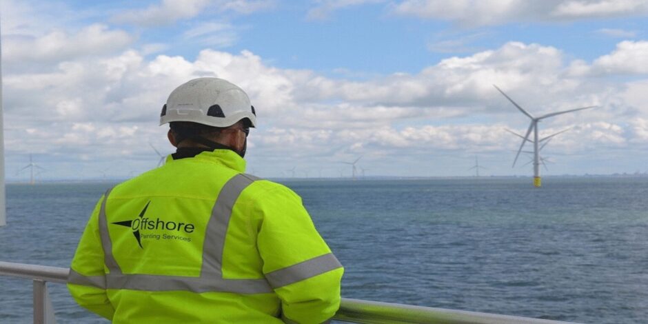 An OPS Wind employee overlooking an offshore wind farm.