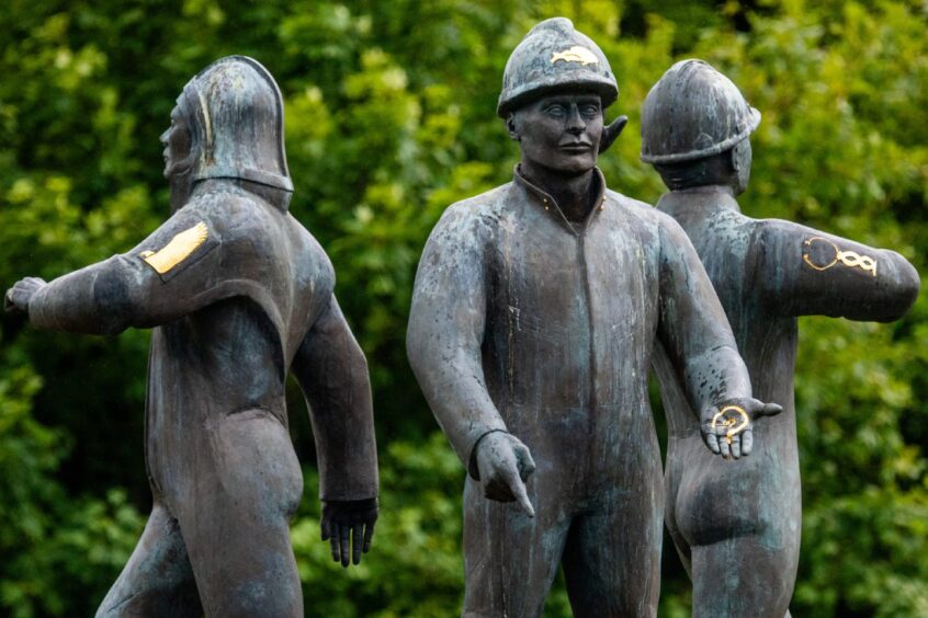 The Piper Alpha memorial statue stands on a plinth carrying the names of all 167 men who died.