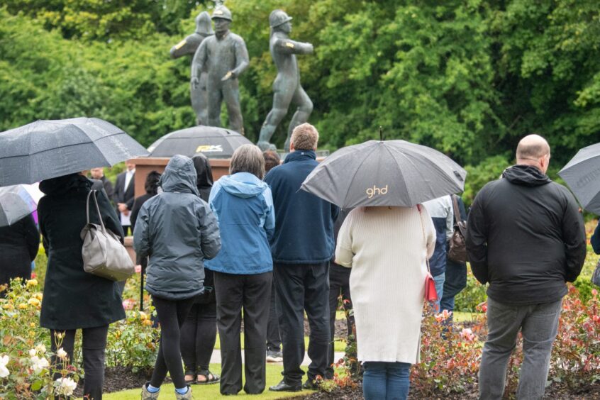 People were not deterred by the rain as they showed up to pay their respects.