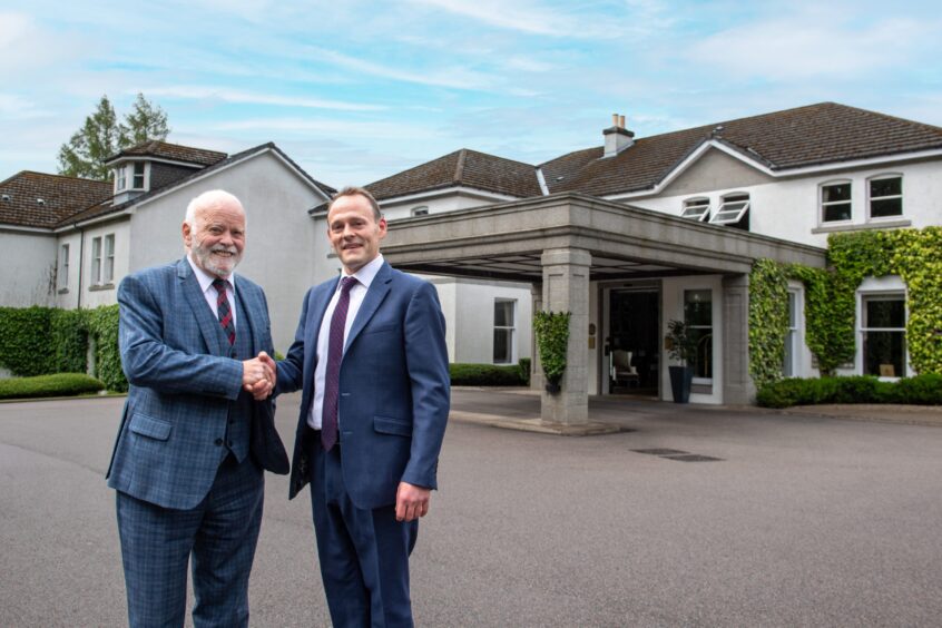 Sir Jim Milne, left, shakes hands on the deal with Marcliffe managing director Ross Spence. Aberdeen. 