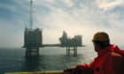 A worker looks out at BP's ETAP platform in the North Sea