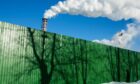 Chimneys emit vapor behind a perimeter fence with tree shadows at the Segezha Pulp and Paper Mill JSC, operated by Segezha Group, in Segezha, Russia, on Friday, March 19, 2021.