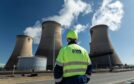 A Drax employee stands outside the Drax Power Station in Yorkshire.