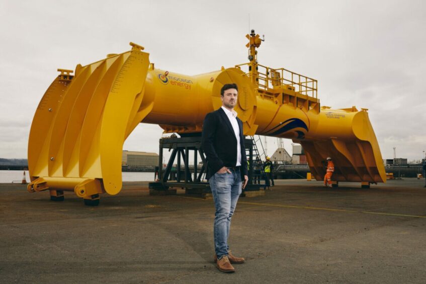 Mocean Energy founder and managing director Cameron McNatt in front of the company's BlueX wave energy converter.