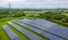 Electricity pylons alongside solar panels at a solar farm near Chesterfield, UK, on Monday, May 20, 2024.