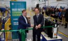 Philippe Piron cuts a ribbon