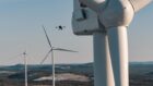 A drone performing a blade inspection on a wind turbine.