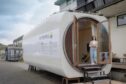 A concept design for a tiny house built from a wind turbine nacelle.