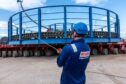 A Briggs Marine worker standing in front of one of Global Energy Group's subsea cable baskets.