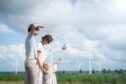 happy family with windfarm in the distance