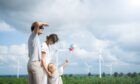 happy family with windfarm in the distance