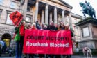 Climate campaigners celebrate outside the Court of Session in Edinburgh following a ruling overturning the approval of Equinor's Rosebank oil development in the North Sea.