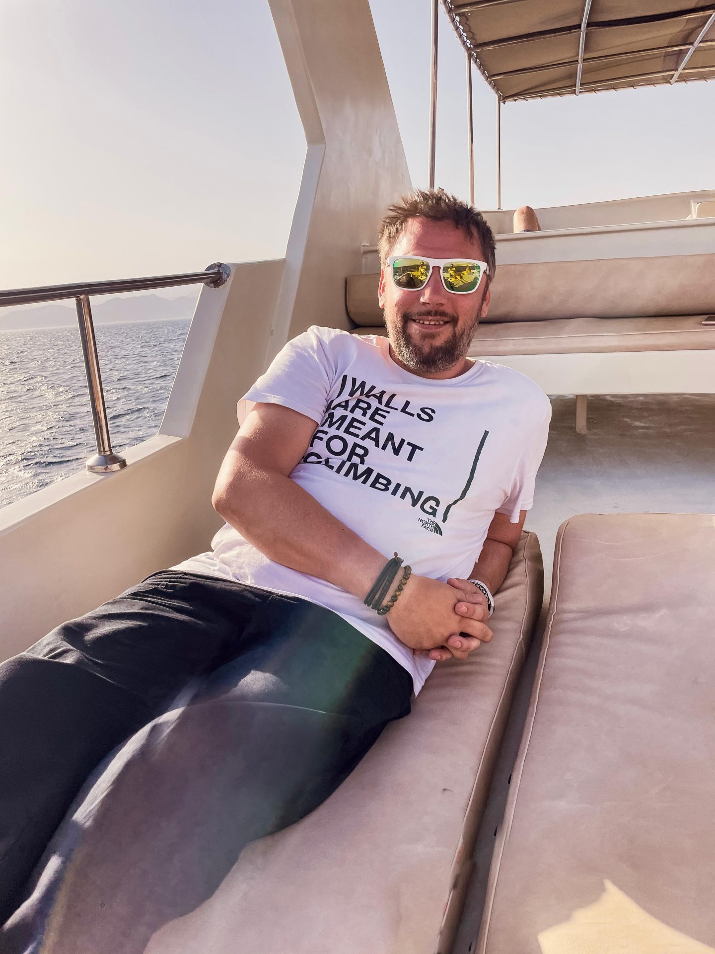 Allan Basil pictured reclining on the deck of a boat.