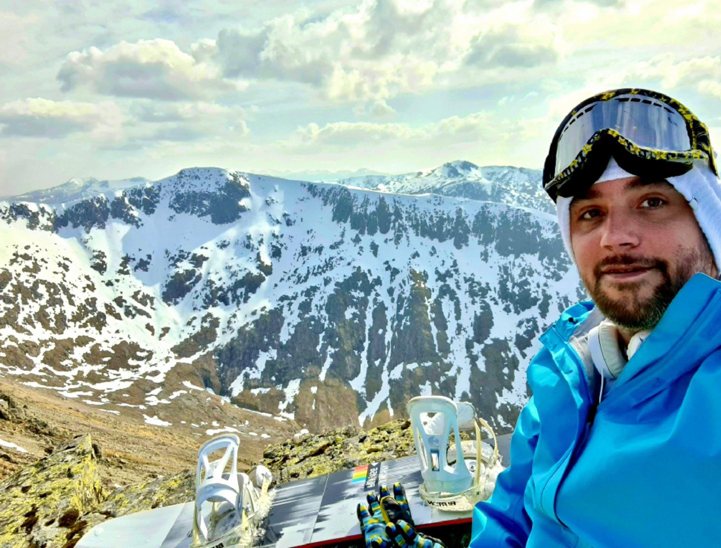 Allan Basil wearing snowboarding gear on top of a mountain.