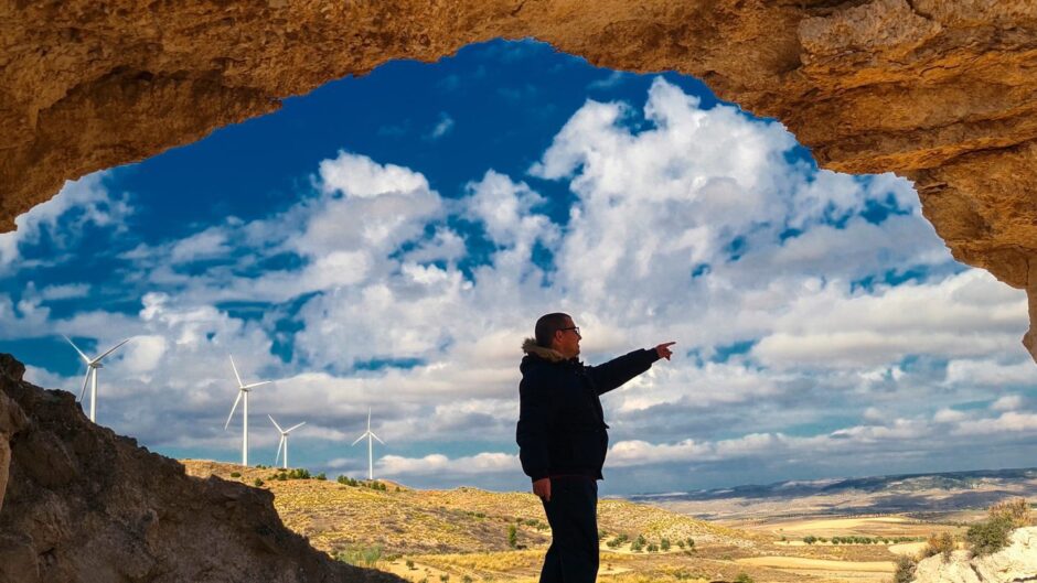 Engineer inside a cave points at wind turbines, a clean energy source to be discussed at the Scottish Energy Futures Conference