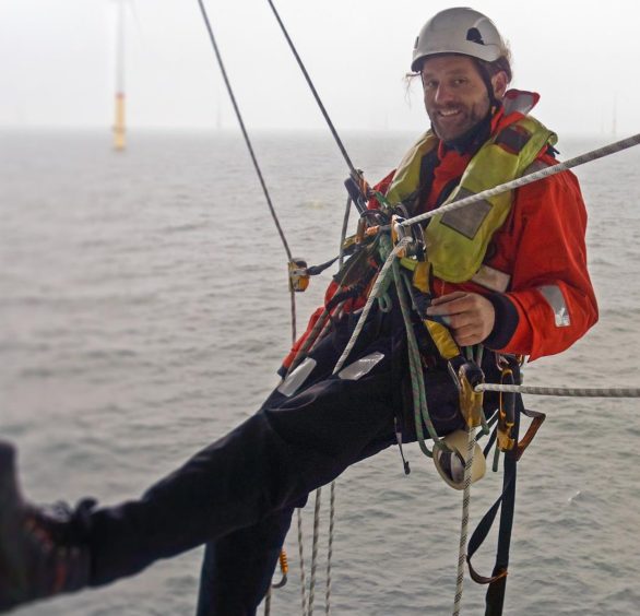 an engineer abseiling at an offshore energy facility