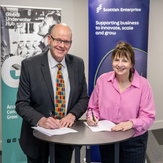 GUH chief exeuctive Neil Gordon and Scottish Enterprise director for energy transition Suzanne Sosna signing the agreement at Subsea Expo 2025.