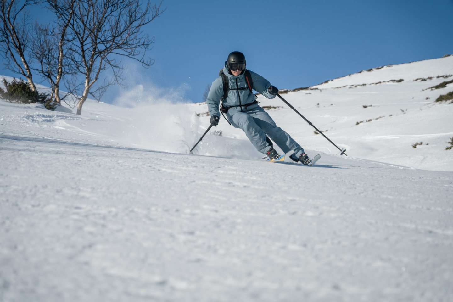 A person skiing on EVI skis made from a recycled wind turbine. 