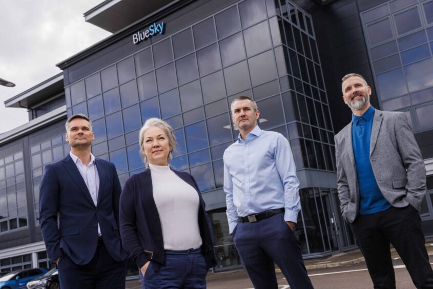 JAB Recruitment's managers, who help clients with their recruitment strategy, pose in front of a BlueSky building