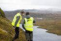 Glen Earrach Energy employees near Loch nam Breac Dearga, the site of a proposed 2 GW pumped storage hydro project.
