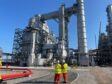 EET workers in front of a newly constructed hydrogen ready furnace at the Stanlow oil refinery.